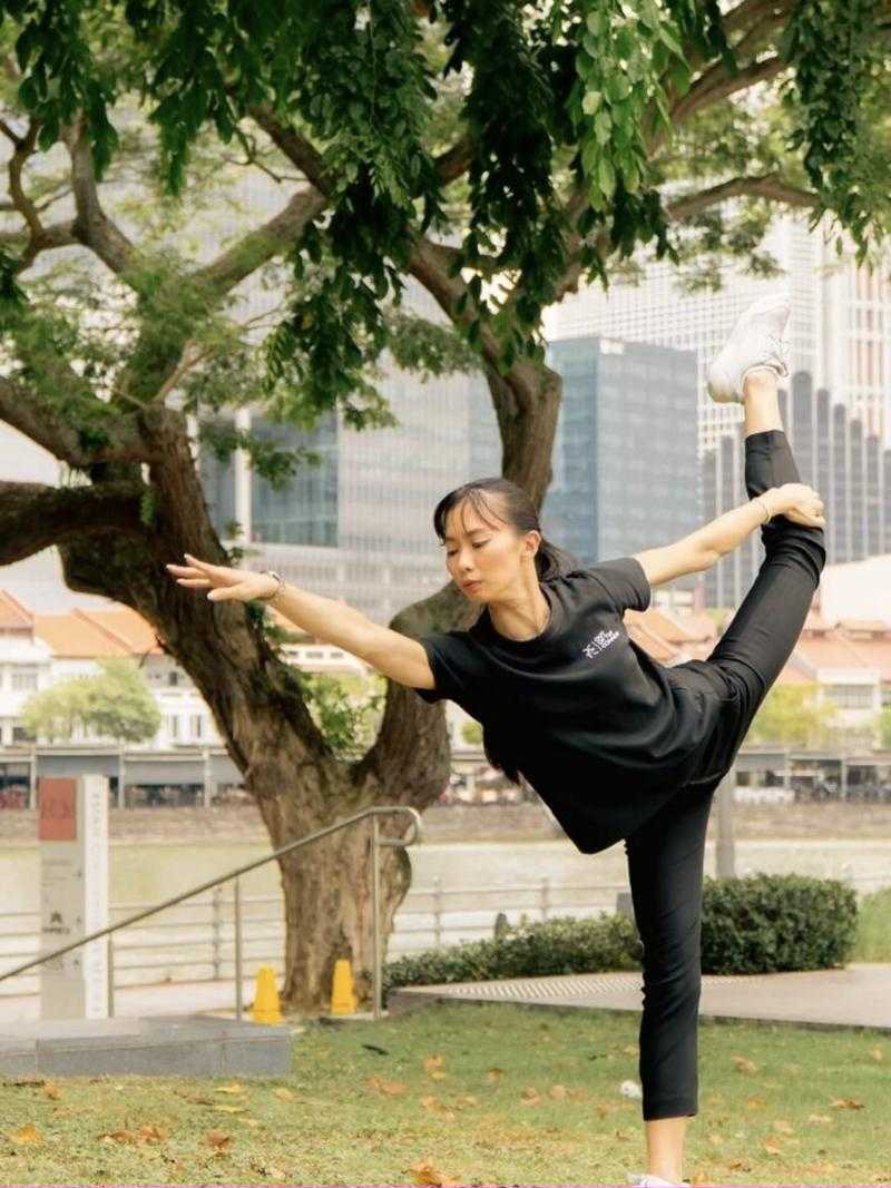 Coach Desiree in a standing balance holding her foot overhead